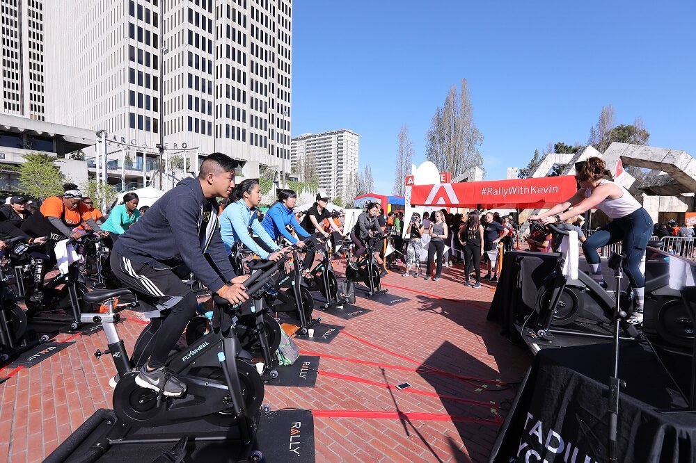 people ride bikes at rally health experiential brand activation