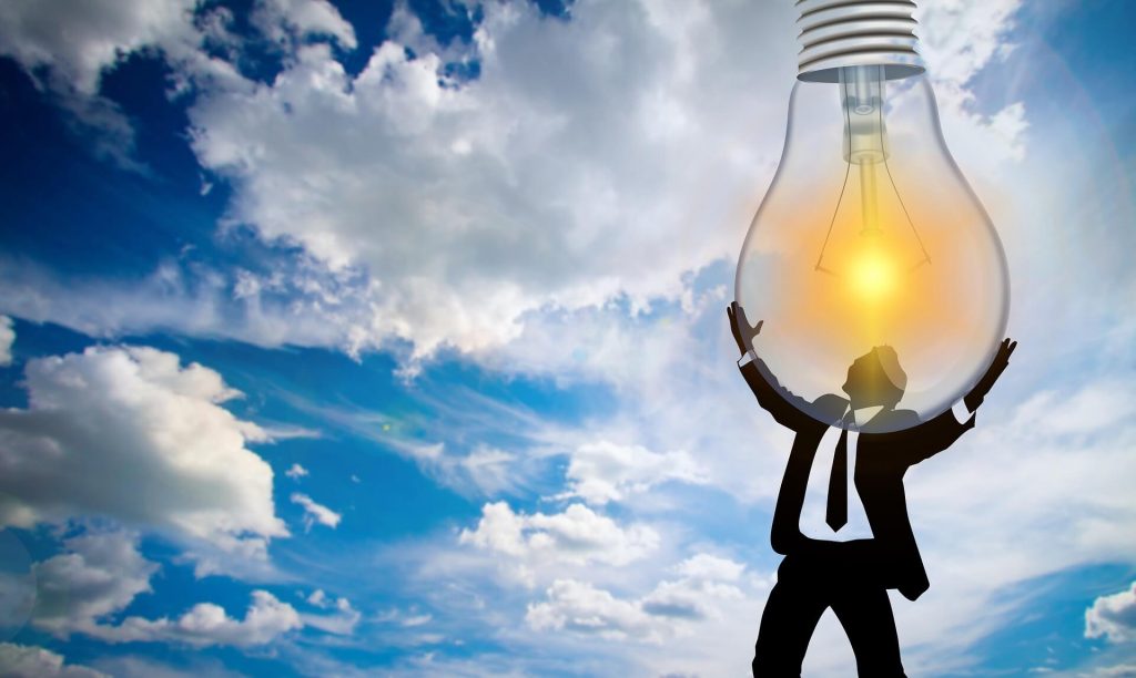 illustration of man in suit holding light bulb in the sky